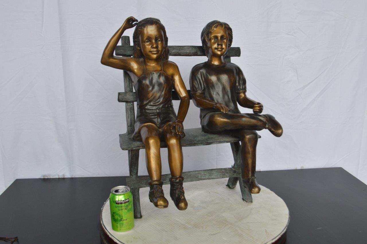 Two Kids Sitting On a Bench Bronze Statue -  Size: 20"L x 18"W x 24"H.