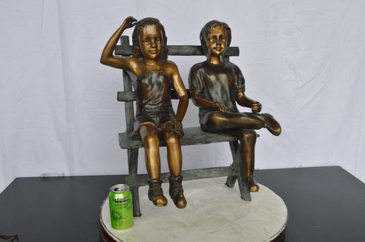 Two Kids Sitting On a Bench Bronze Statue -  Size: 20"L x 18"W x 24"H.