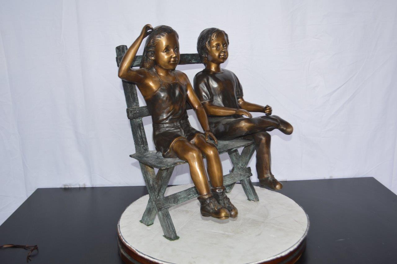 Two Kids Sitting On a Bench Bronze Statue -  Size: 20"L x 18"W x 24"H.