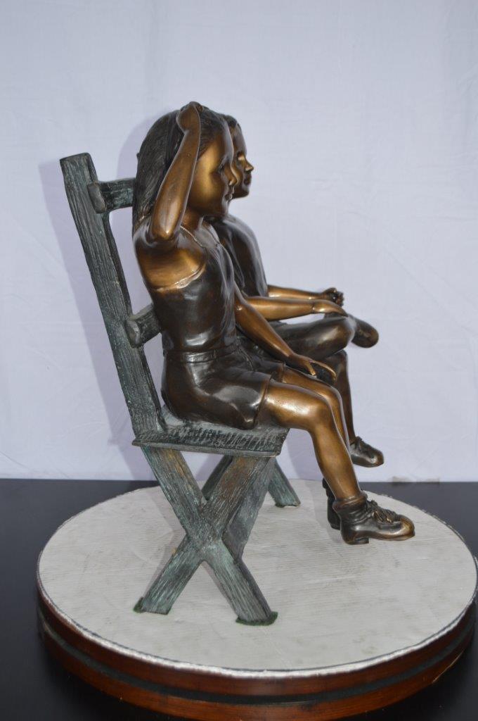 Two Kids Sitting On a Bench Bronze Statue -  Size: 20"L x 18"W x 24"H.