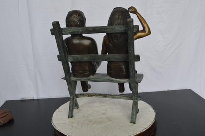 Two Kids Sitting On a Bench Bronze Statue -  Size: 20"L x 18"W x 24"H.