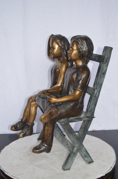 Two Kids Sitting On a Bench Bronze Statue -  Size: 20"L x 18"W x 24"H.