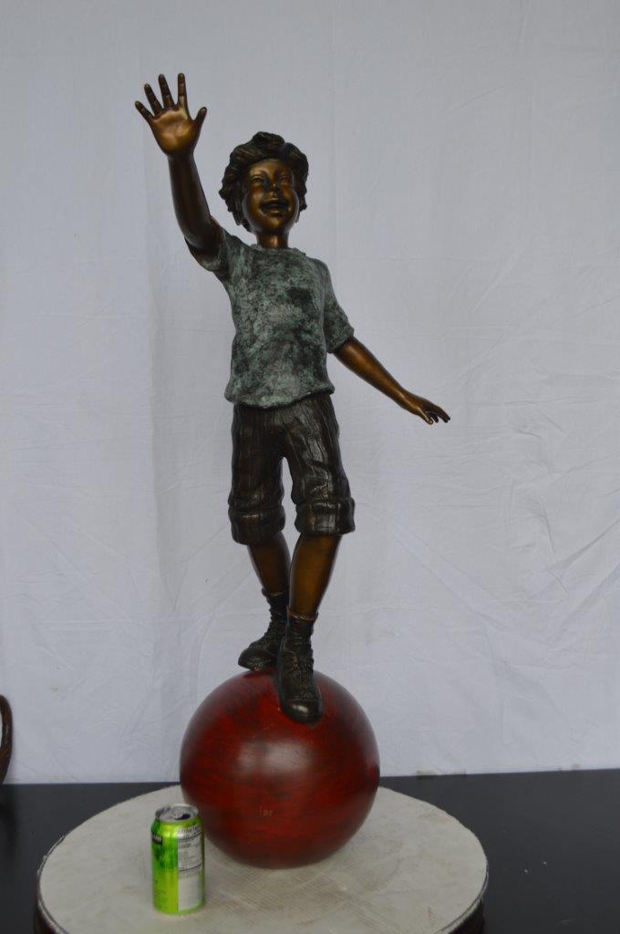 Boy on Ball Bronze Statue - Street Performer -  Size: 23"L x 12"W x 39"H.
