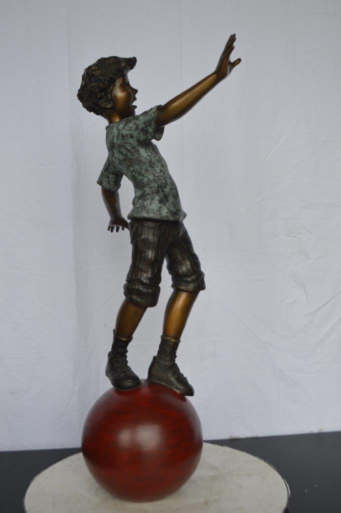 Boy on Ball Bronze Statue - Street Performer -  Size: 23"L x 12"W x 39"H.
