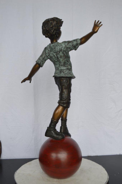 Boy on Ball Bronze Statue - Street Performer -  Size: 23"L x 12"W x 39"H.
