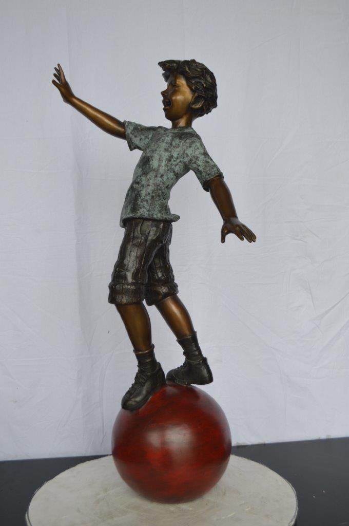 Boy on Ball Bronze Statue - Street Performer -  Size: 23"L x 12"W x 39"H.