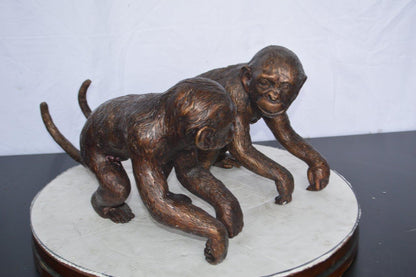 Pair of monkeys looking at each other bronze statue -  Size: 23"L x 7"W x 11"H.