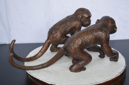 Pair of monkeys looking at each other bronze statue -  Size: 23"L x 7"W x 11"H.