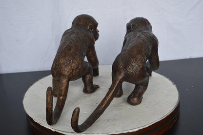 Pair of monkeys looking at each other bronze statue -  Size: 23"L x 7"W x 11"H.