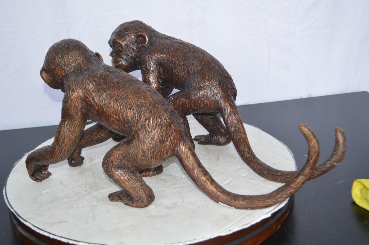 Pair of monkeys looking at each other bronze statue -  Size: 23"L x 7"W x 11"H.