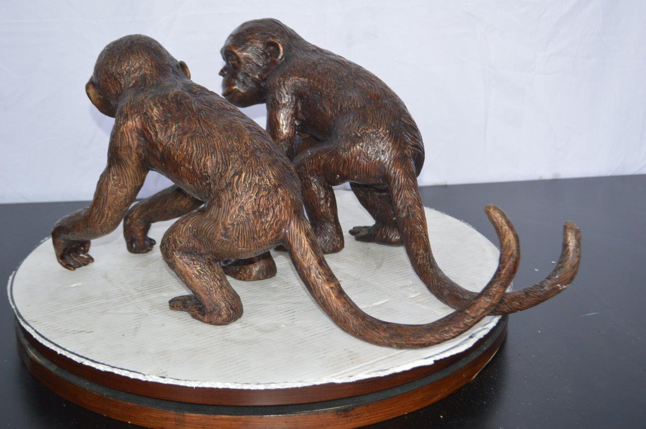 Pair of monkeys looking at each other bronze statue -  Size: 23"L x 7"W x 11"H.