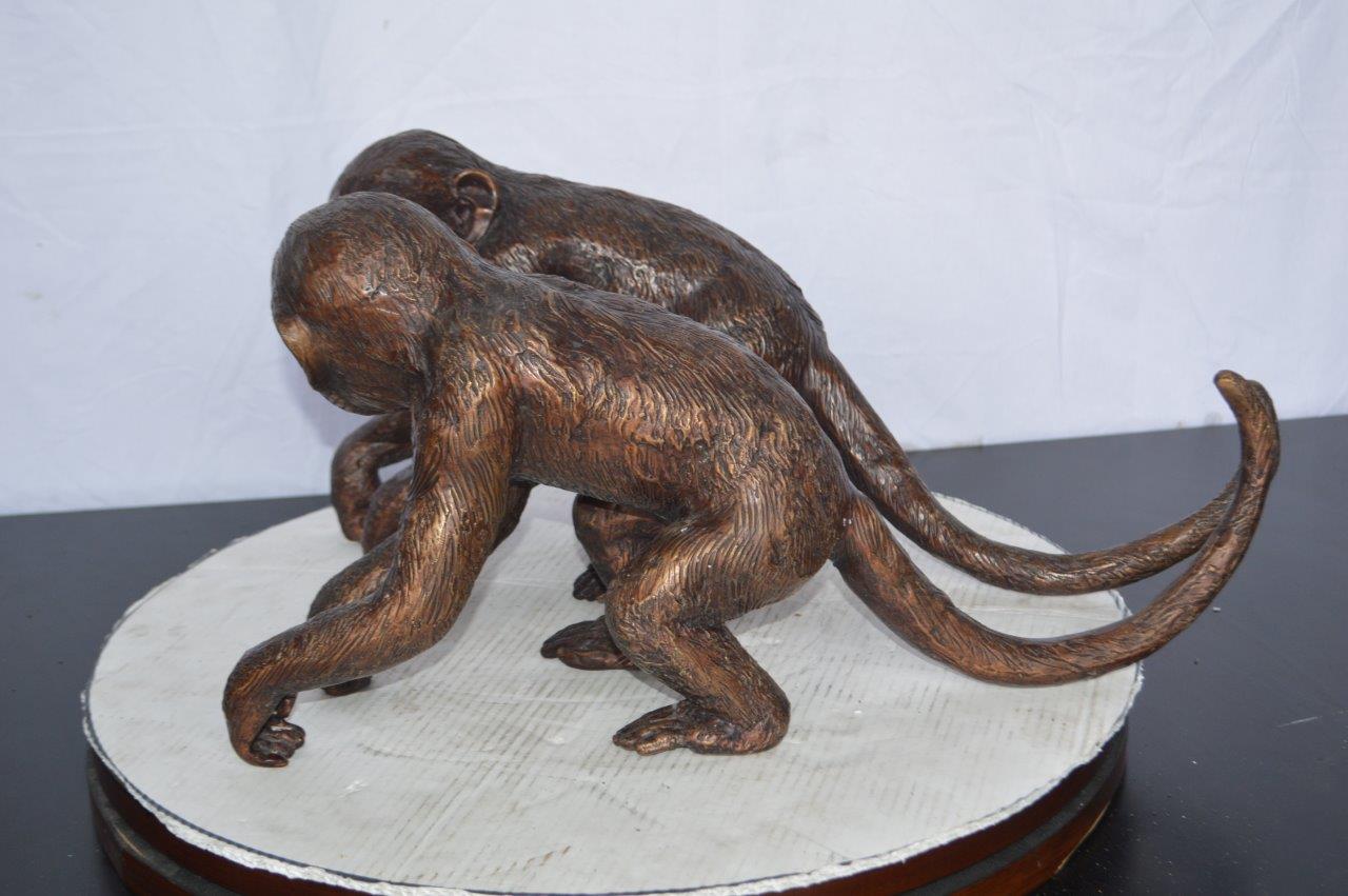 Pair of monkeys looking at each other bronze statue -  Size: 23"L x 7"W x 11"H.
