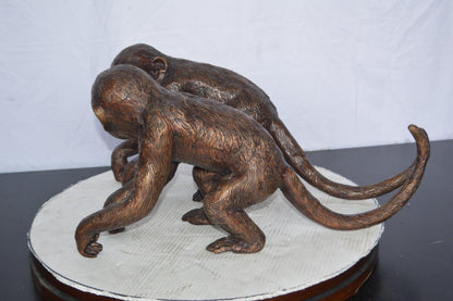 Pair of monkeys looking at each other bronze statue -  Size: 23"L x 7"W x 11"H.