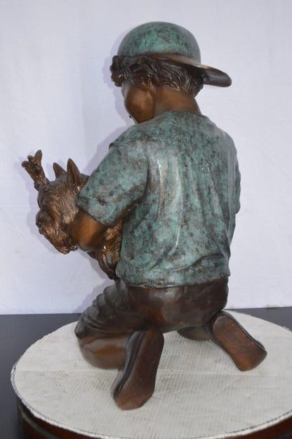Young Child Playing With His Dog Bronze Statue -  Size: 18"L x 17"W x 26"H.
