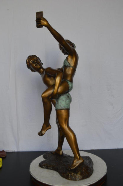 Kids Taking a Selfie W a Smartphone Bronze Statue -  Size: 23"L x 20"W x 43"H.