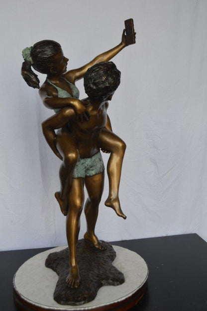 Kids Taking a Selfie W a Smartphone Bronze Statue -  Size: 23"L x 20"W x 43"H.