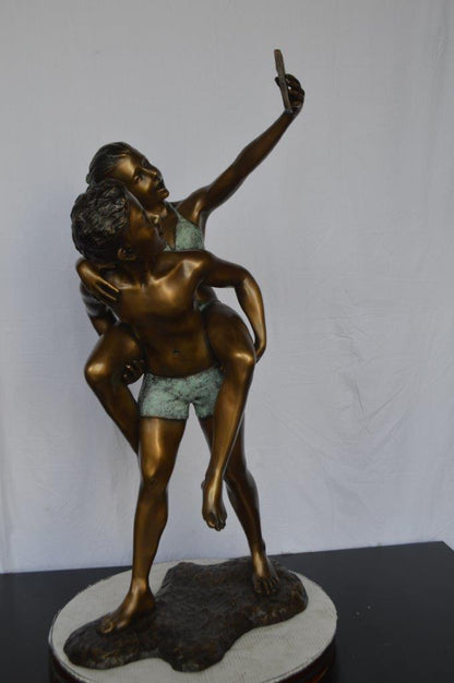 Kids Taking a Selfie W a Smartphone Bronze Statue -  Size: 23"L x 20"W x 43"H.