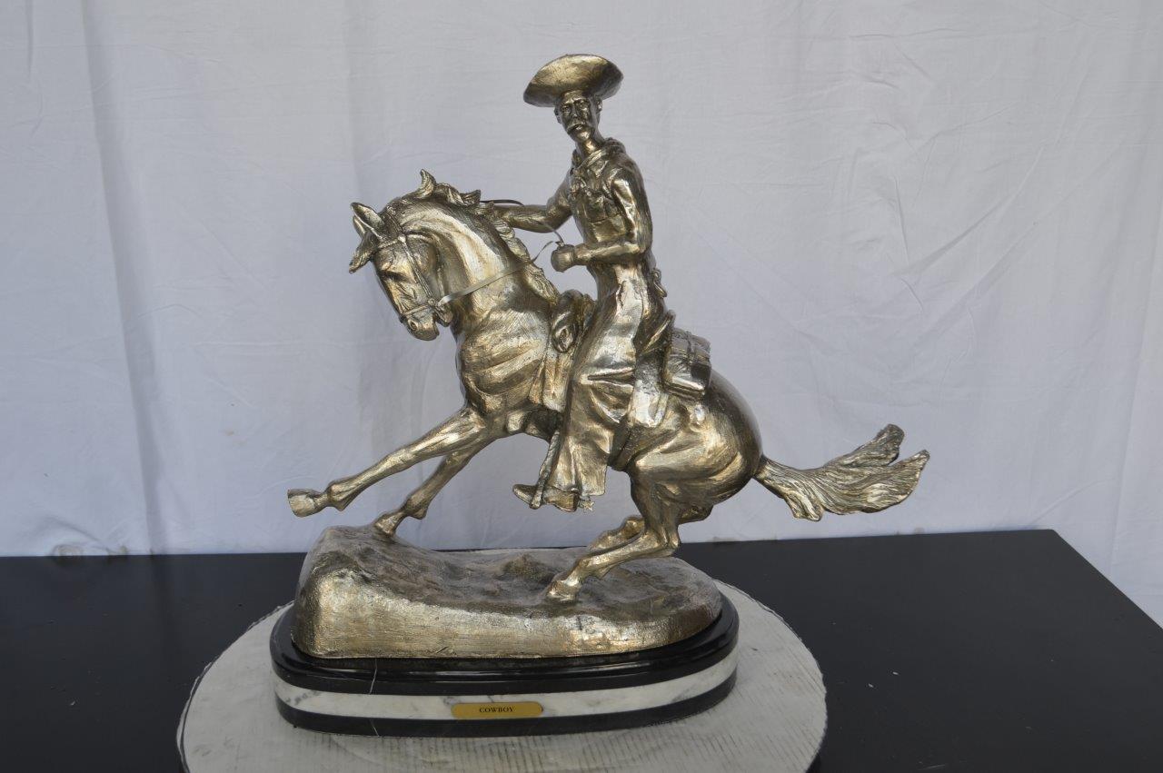 Remington Cowboy silver finished Bronze Statue -  Size: 24"L x 9"W x 24"H.