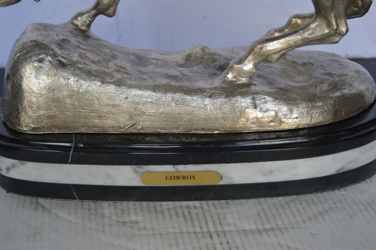 Remington Cowboy silver finished Bronze Statue -  Size: 24"L x 9"W x 24"H.