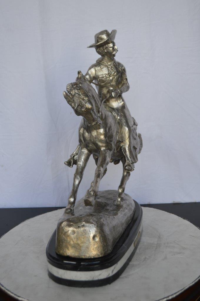 Remington Cowboy silver finished Bronze Statue -  Size: 24"L x 9"W x 24"H.