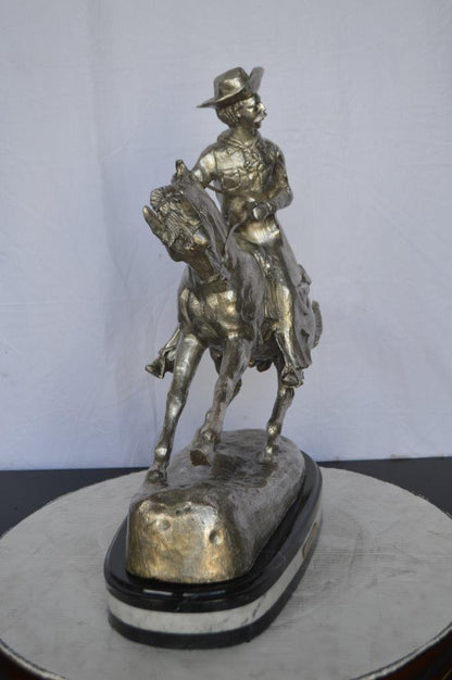 Remington Cowboy silver finished Bronze Statue -  Size: 24"L x 9"W x 24"H.