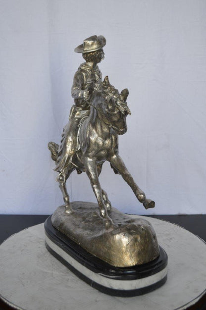 Remington Cowboy silver finished Bronze Statue -  Size: 24"L x 9"W x 24"H.