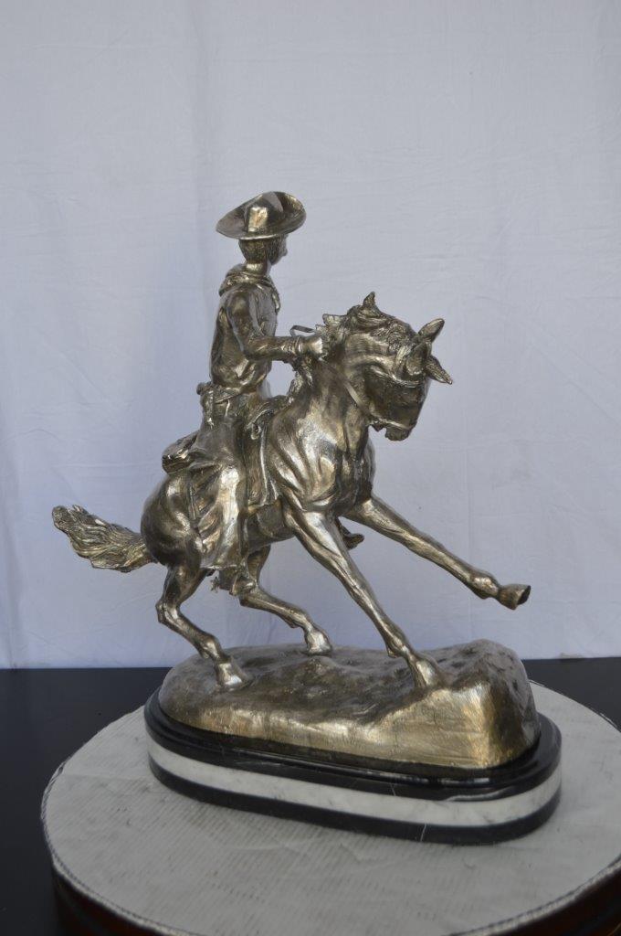 Remington Cowboy silver finished Bronze Statue -  Size: 24"L x 9"W x 24"H.