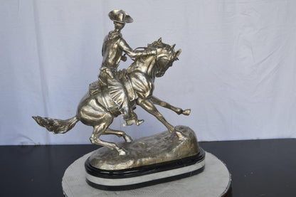 Remington Cowboy silver finished Bronze Statue -  Size: 24"L x 9"W x 24"H.