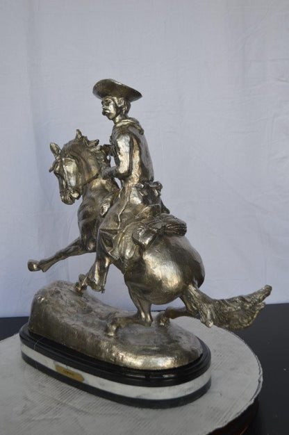 Remington Cowboy silver finished Bronze Statue -  Size: 24"L x 9"W x 24"H.
