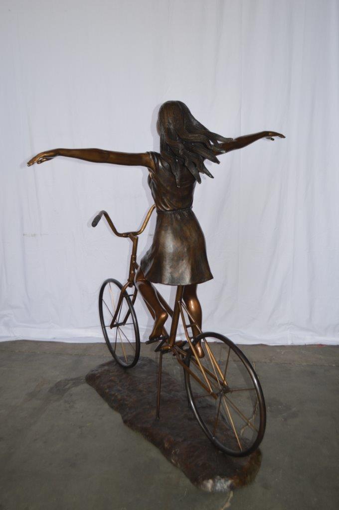 Girl Riding Hands Free life Size Bronze Statue -  Size: 53"L x 62"W x 61"H.
