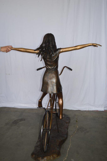Girl Riding Hands Free life Size Bronze Statue -  Size: 53"L x 62"W x 61"H.