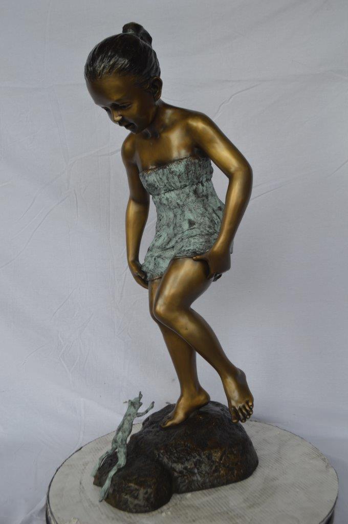 Girl looking at a frog bronze statue -  Size: 16"L x 13"W x 36"H.