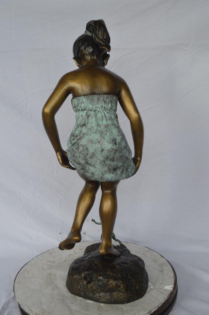 Girl looking at a frog bronze statue -  Size: 16"L x 13"W x 36"H.
