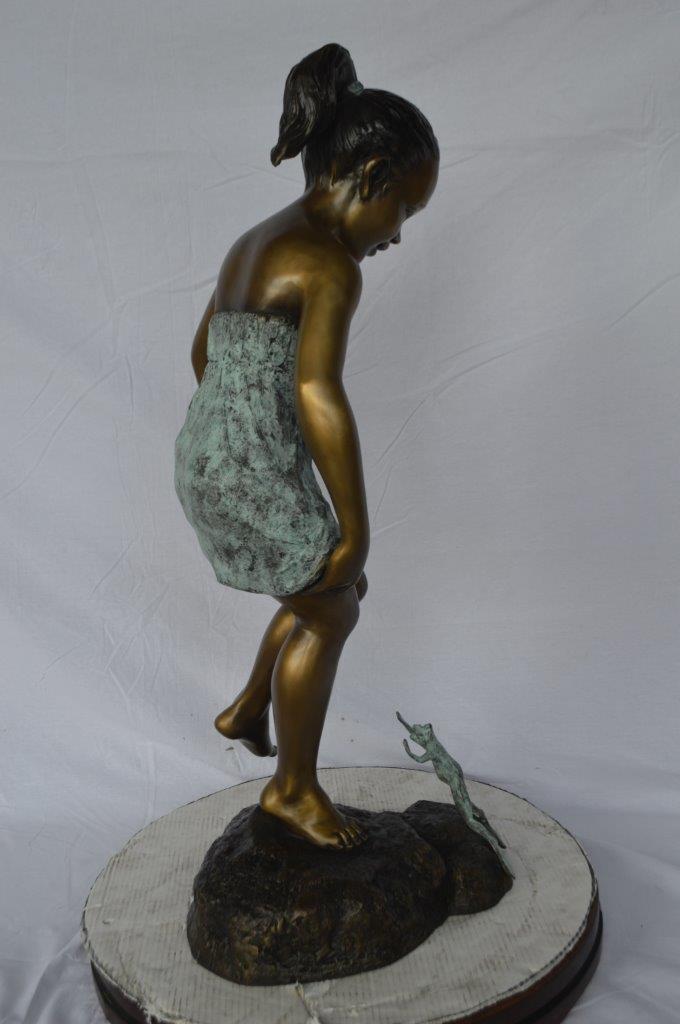 Girl looking at a frog bronze statue -  Size: 16"L x 13"W x 36"H.