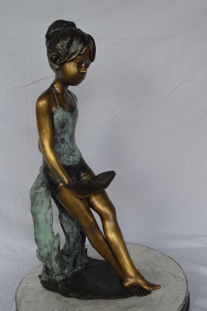 Girl sitting and reading a book bronze statue -  Size: 19"L x 15"W x 36"H.