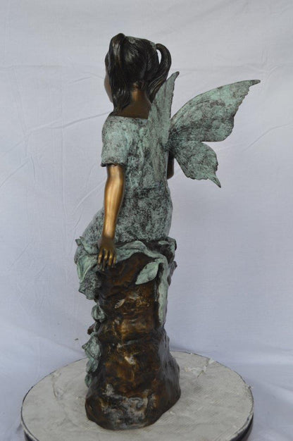 Angel girl sitting with a rose bronze statue -  Size: 22"L x 27"W x 37"H.
