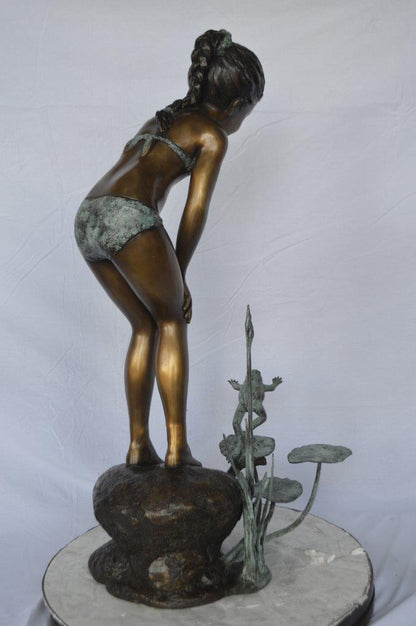 Girl looking at frog jumping bronze fountain -  Size: 21"L x 15"W x 38"H.