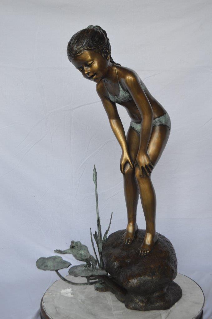 Girl looking at frog jumping bronze fountain -  Size: 21"L x 15"W x 38"H.