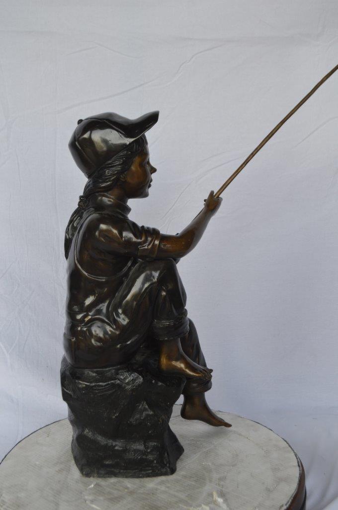 Young Boy sitting on a rock fishing bronze statue -  Size: 31"L x 9"W x 33"H.