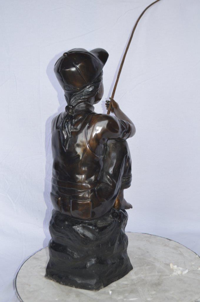 Young Boy sitting on a rock fishing bronze statue -  Size: 31"L x 9"W x 33"H.