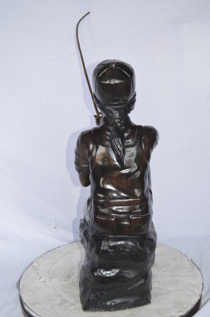Young Boy sitting on a rock fishing bronze statue -  Size: 31"L x 9"W x 33"H.