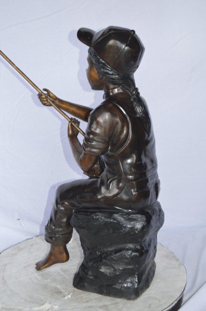 Young Boy sitting on a rock fishing bronze statue -  Size: 31"L x 9"W x 33"H.