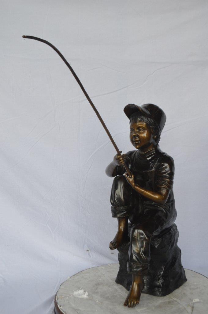 Young Boy sitting on a rock fishing bronze statue -  Size: 31"L x 9"W x 33"H.