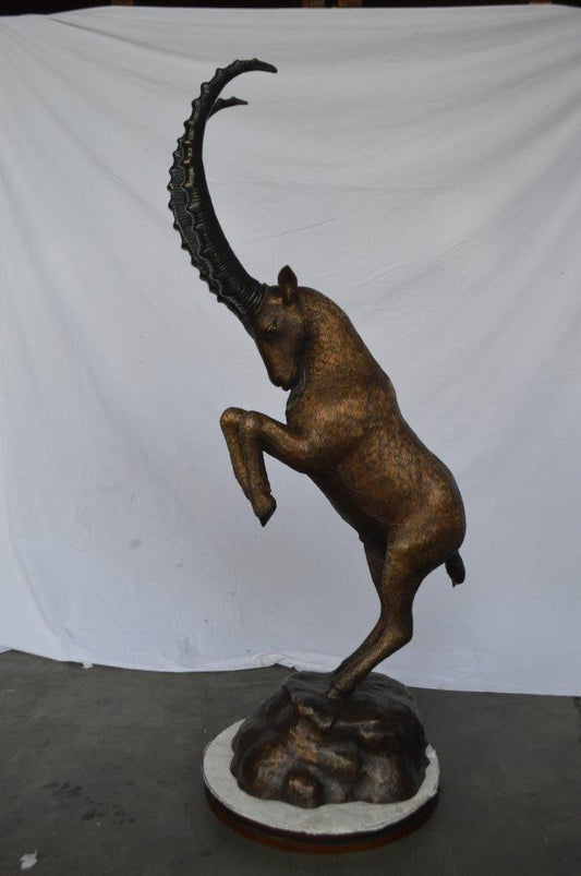 Mountain goat on hind legs bronze statue -  Size: 36"L x 16"W x 66"H.