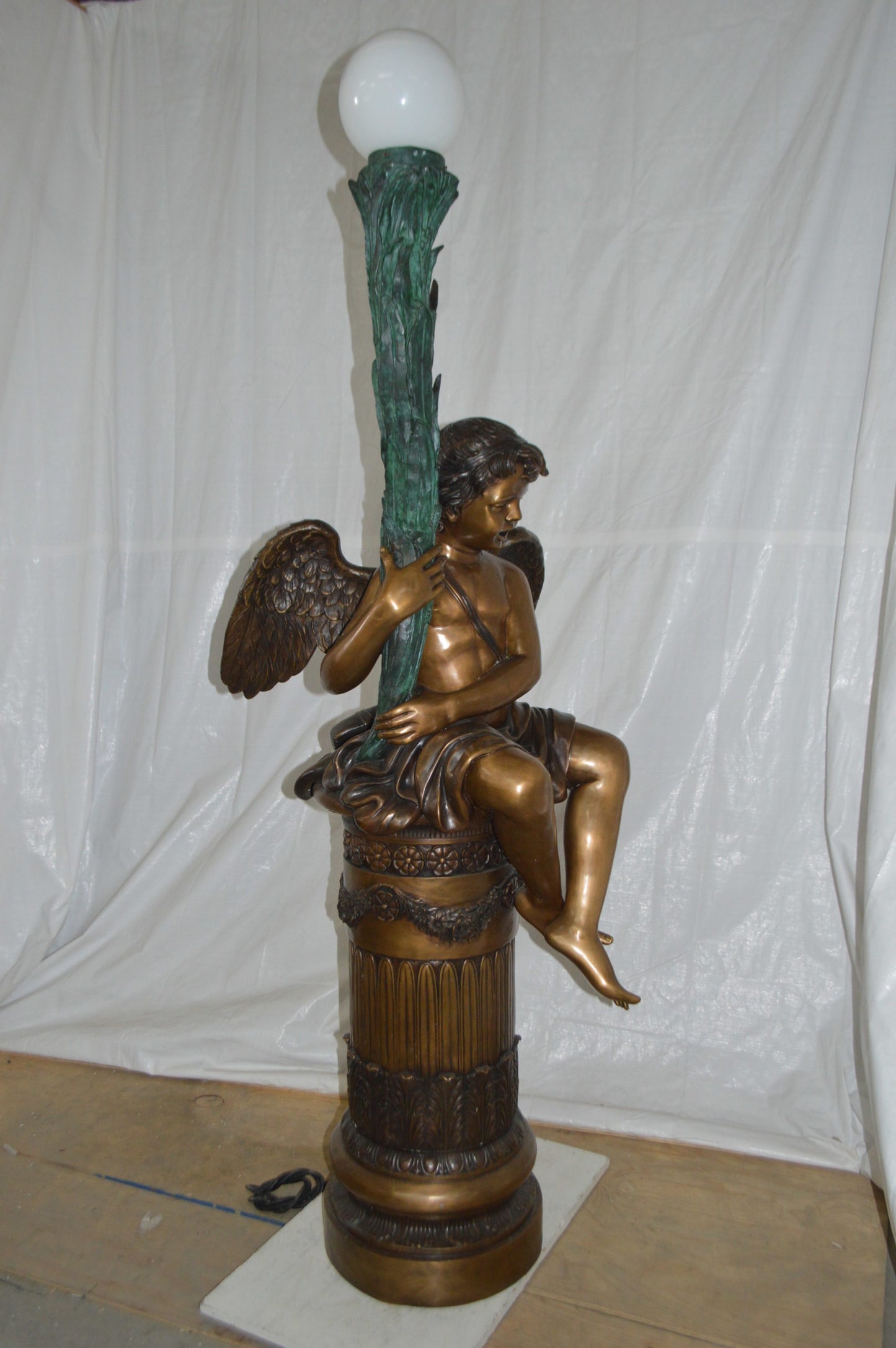 Pair of Cupid on stand lamp -  Size: 28"L x 24"W x 90"H.