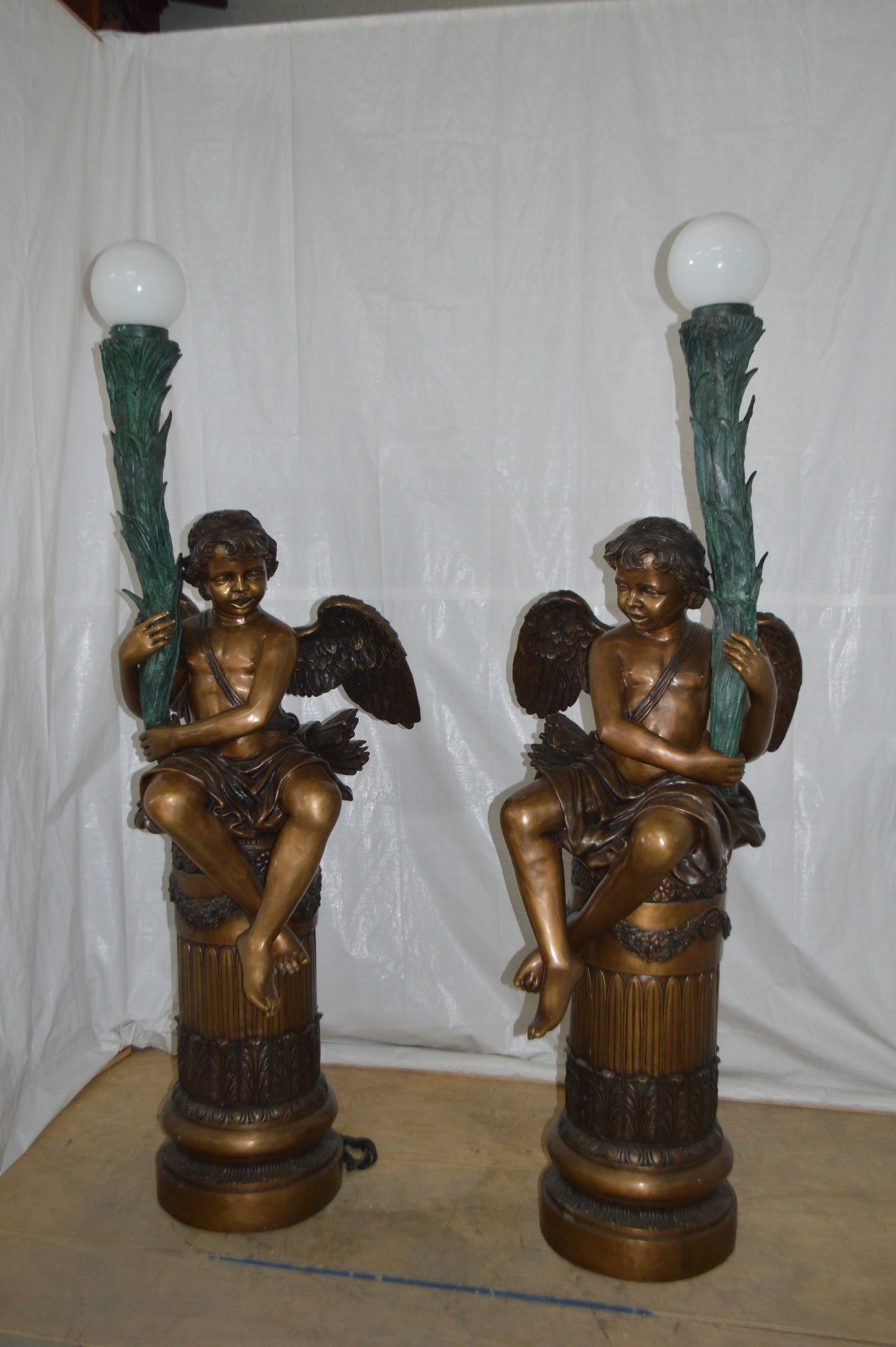Pair of Cupid on stand lamp -  Size: 28"L x 24"W x 90"H.