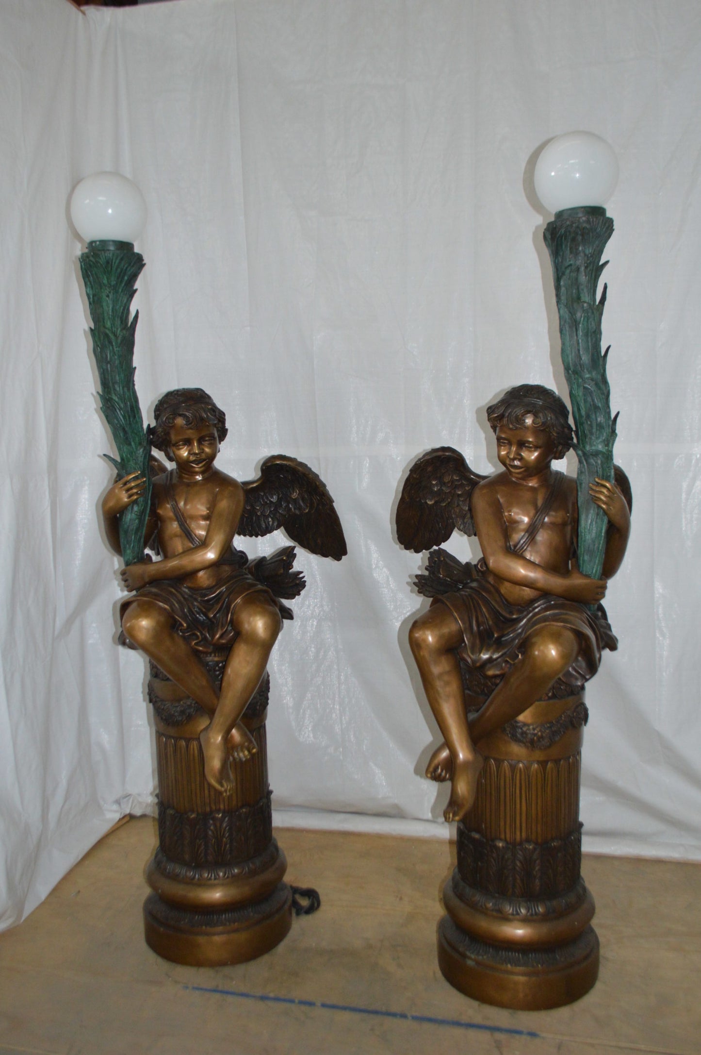 Pair of Cupid on stand lamp -  Size: 28"L x 24"W x 90"H.