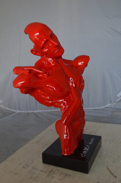 Modern resin statue of a man hugged by a woman -  Size: 17"L x 8"W x 24"H.