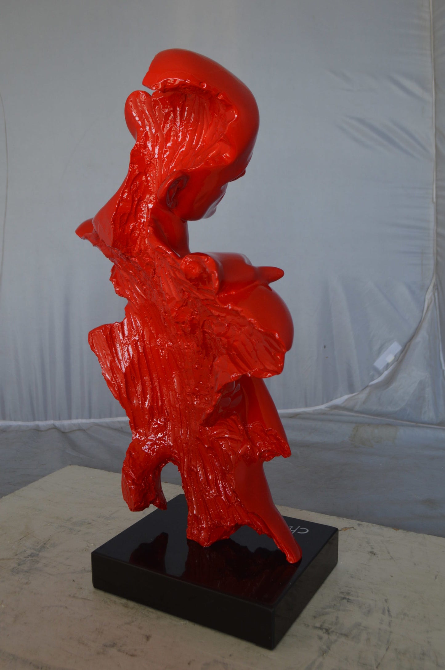 Modern resin statue of a man hugged by a woman -  Size: 17"L x 8"W x 24"H.