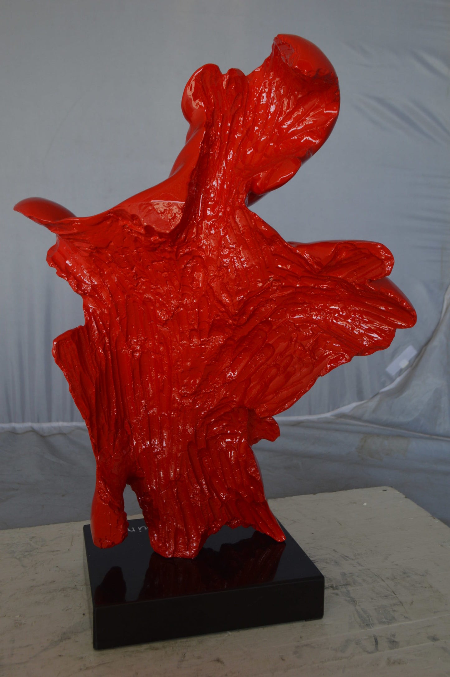 Modern resin statue of a man hugged by a woman -  Size: 17"L x 8"W x 24"H.